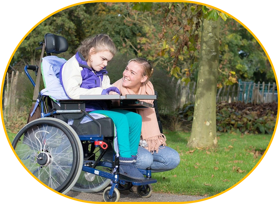 A man and woman sitting in a wheelchair.