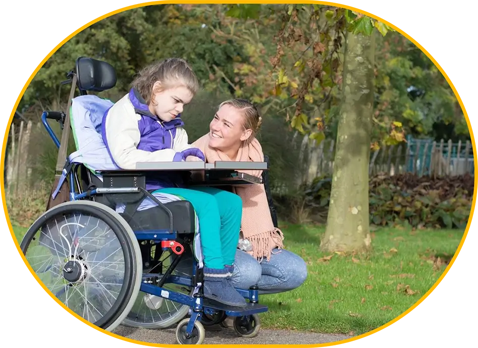 A man and woman sitting in a wheelchair.